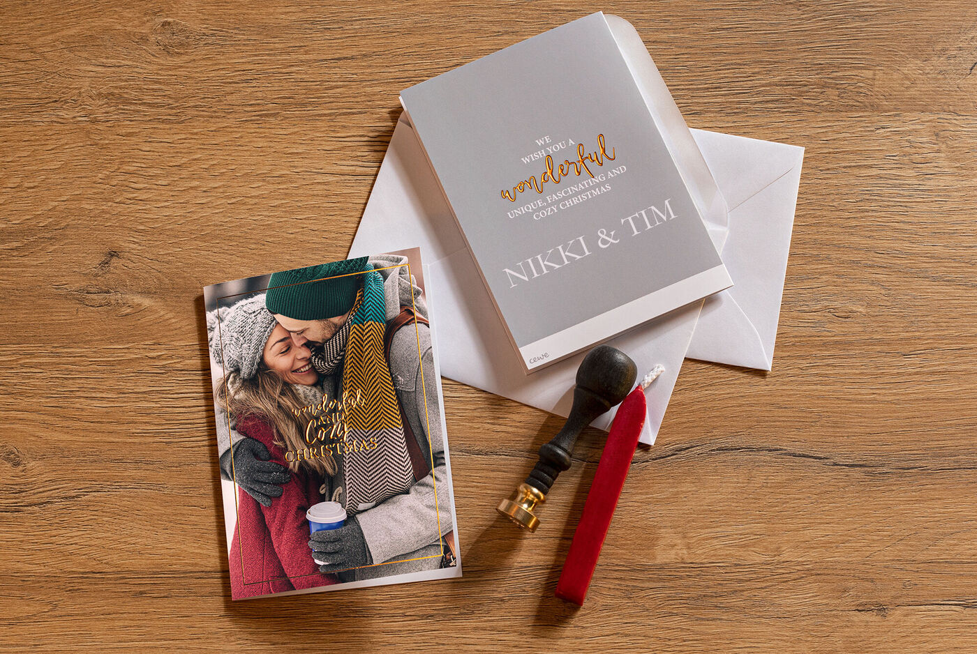 A loving winter scene on a greeting card with the text "Wishing you a wonderful holiday season," surrounded by an envelope and a seal. The couple on the card shows joy and affection.